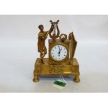 An early 19th century French empire gilt bronze clock case, surmounted with a lady with a lyre, a