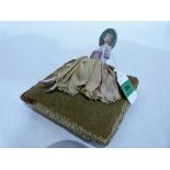 An early 20th century pin cushion doll, the cushion 6¼'' wide