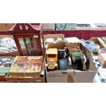 A box of sundries, a small display case, Giles annuals and videos