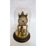 A brass anniversary clock under a glass dome. 11½'' high
