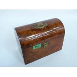A Victorian burr walnut tea caddy, the domed lid with brass cartouche and scroll. 9'' wide