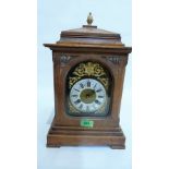 A German oak mantle clock, the Junghans movement striking on a coiled gong, the brass dial with