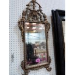 A 19th century gilt composition Adam style looking glass with bevelled plate. 30'' high