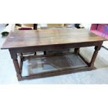 A late 17th century joined oak farmhouse table, the three plank cleated top on turned and squared