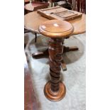 A carved wood jardinière stand with open twist turned column