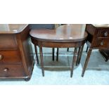 A Regency mahogany demi-lune tea table, the fold over top with reeded edge, on ring turned legs.