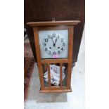 An oak cased wall clock