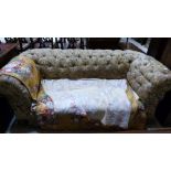 An Edwardian drop-end deep buttoned chesterfield requiring renovation