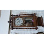 A walnut and inlaid American wall clock, the two train movement striking on a bell. 36'' high