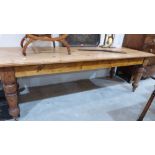 A Victorian pine farmhouse table on turned legs with castors. 93'' long