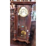 A walnut cased Vienna wall clock. 38'' high