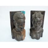 A pair of African lignum-vitae bookends carved in the form of female busts. 9'' high