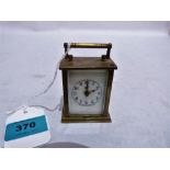 An unusual miniature brass carriage clock, the enamel dial and backplate signed Waterbury Clock