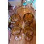 An amber glass bowl and four drinking glasses