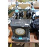 A French black slate mantle clock 11'' high; a pair of garnitures (one A.F) and a pair of speltar