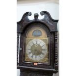 A 19th century oak cased longcase clock, the case later carved, the breakarch dial with silvered