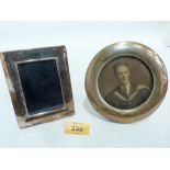 An early 20th century silver and oak photograph frame, 5'' diameter and a silver photograph frame of