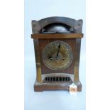 A late 19th century Arts and Crafts oak and silvered brass bracket clock in the manner of