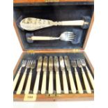An oak canteen of plated fish cutlery comprising six knives and forks, a fish slice and serving