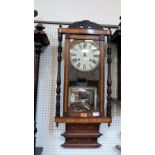 An American wall clock in inlaid walnut case. Early 20th century. 36'' high