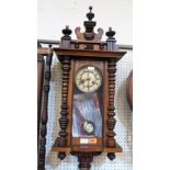 A Vienna style walnut clock, the two train movement striking on a coiled gong. 35'' high