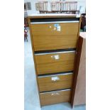A woodgrain finish four drawer filing cabinet