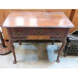 A George III mahogany lowboy, the moulded top over three drawers, on cabriole legs with pad feet.