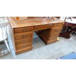 A walnut veneered partner's desk of recent manufacture, the leather inlet top with three frieze