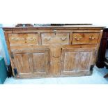 A 19th century joined pine cupboard with three drawers over cupboard enclosed by a pair of