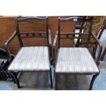 A pair of Regency style elbow chairs