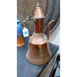 A Middle Eastern copper water pot with conical cover. 15'' high