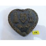 A wax heart form box, the cover moulded with a lady and gentleman in 17th century dress.