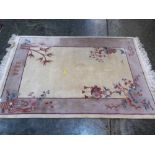 A cream ground Chinese rug. 82'' x 53''