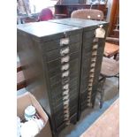 A pair of 15 drawer metal cabinets containing tools and sundries