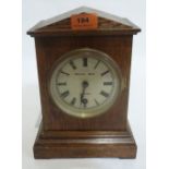 An early 20th century oak cased mantle timepiece, the silvered dial signed Morath Bros, Liverpool.