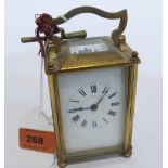 A French brass carriage timepiece with lever escapement. 4' high