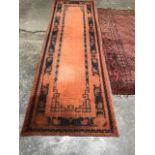 A brown ground eastern runner. 120' x 38 and a red ground eastern rug 86' x 48'