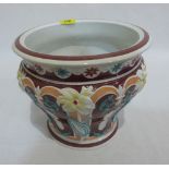 A majolica style jardiniere decorated in low relief. Bears registration kite mark. 9' high