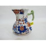 A Masons Ironstone octagonal jug, decorated in Imari style with green branch handle. 9' high