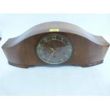 An Art Deco walnut mantle clock, the three train movement striking and chiming on five tubular