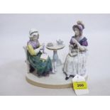 A continental porcelain group of two ladies sewing and taking tea. 7' high