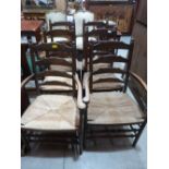 A set of six ladderback chairs with rush seats, the set to include two carvers