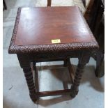 An oak carved occasional table on bobbin turned legs