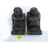 A pair of carved oak figural corbels. 8' high