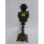 An Arts and Crafts iron and brass oil lamp. c.1910. 18' high