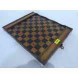 An early 20th century walnut and ebonised draughts board, the compartments for the draughts pieces