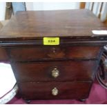A mahogany miniature chest of three drawers. 13 1/2' high