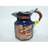 A Masons style octagonal jug decorated to two reserves, with serpent handle. 7 1/2' high
