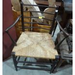 A Morris style elbow chair with rush seat