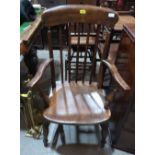 A Victorian ash and oak stickback elbow chair